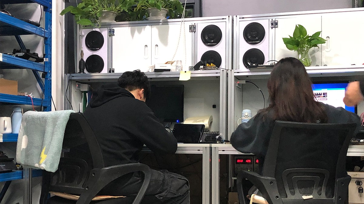 People evaluating electronics at a development workstation